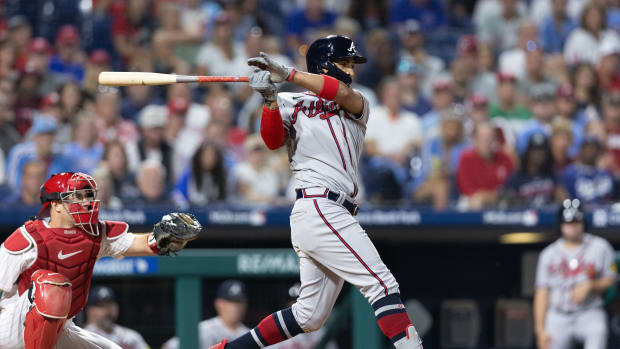 Sep 12, 2023; Philadelphia, Pennsylvania, USA; Atlanta Braves left fielder Eddie Rosario (8) hits an RBI single during the tenth inning against the Philadelphia Phillies at Citizens Bank Park.